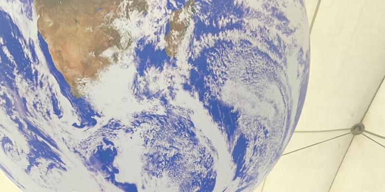 Image of the globe with swirling clouds