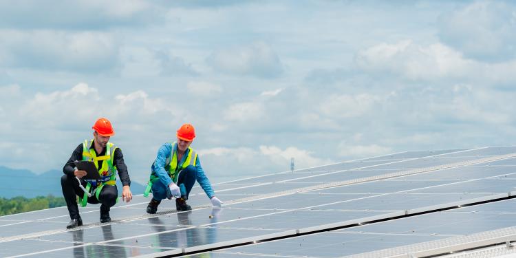 Workers on a solar panel roof