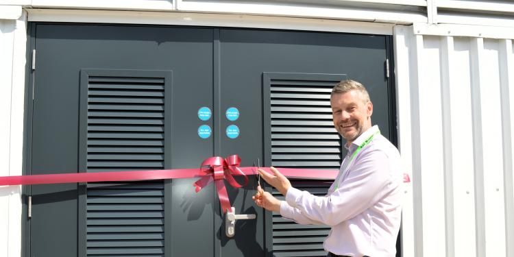 Ian Rodger cutting ribbon at museum 