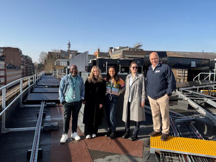 LSHTM line up photo on top of roof with heat pumps