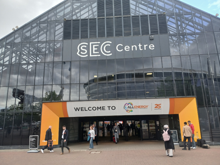 A large glass triangular building with an orange entrance and the name SEC Centre in white above the door.